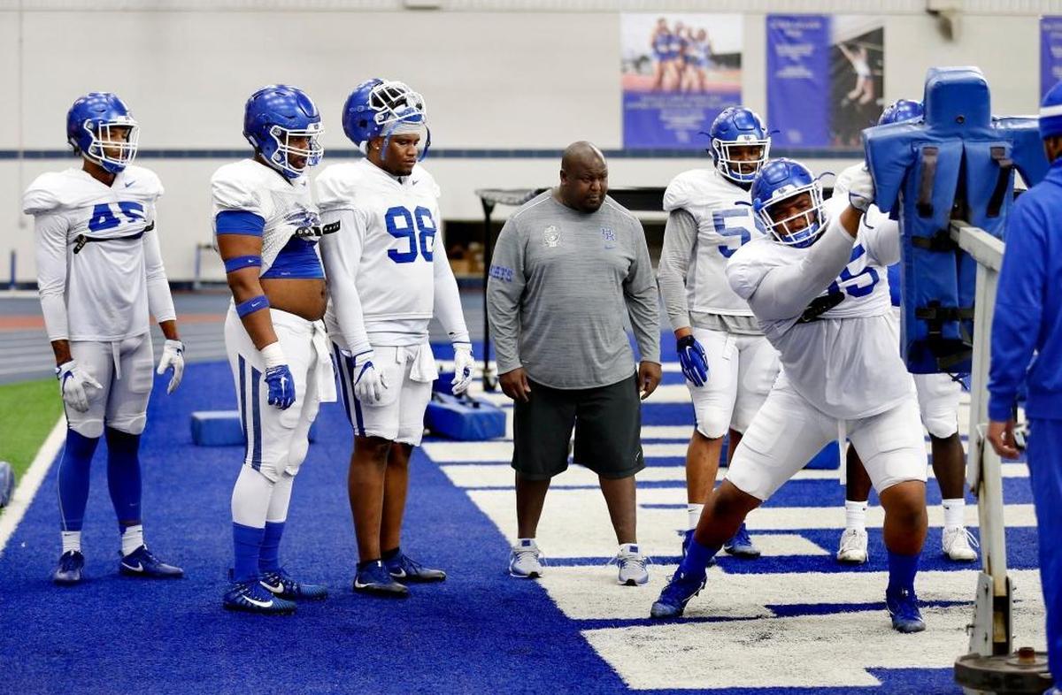 Kentucky defensive line coach Derrick LeBlanc, center, watched as defensive lineman Quinton Bohanna, right, worked during spring practice. “Great defenses in this league are dominated by defensive linemen,” Coach Mark Stoops said. “And we are getting much better. I feel much more solid.”