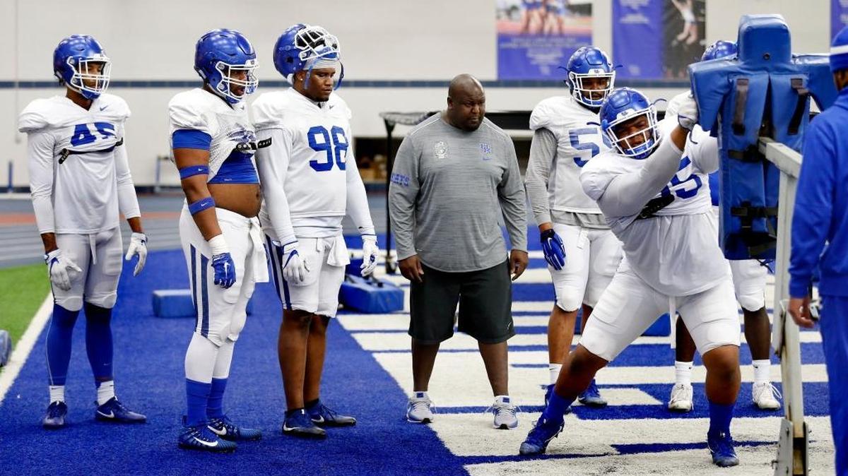 Kentucky defensive line coach Derrick LeBlanc, center, watched as defensive lineman Quinton Bohanna, right, worked during spring practice. “Great defenses in this league are dominated by defensive linemen,” Coach Mark Stoops said. “And we are getting much better. I feel much more solid.”