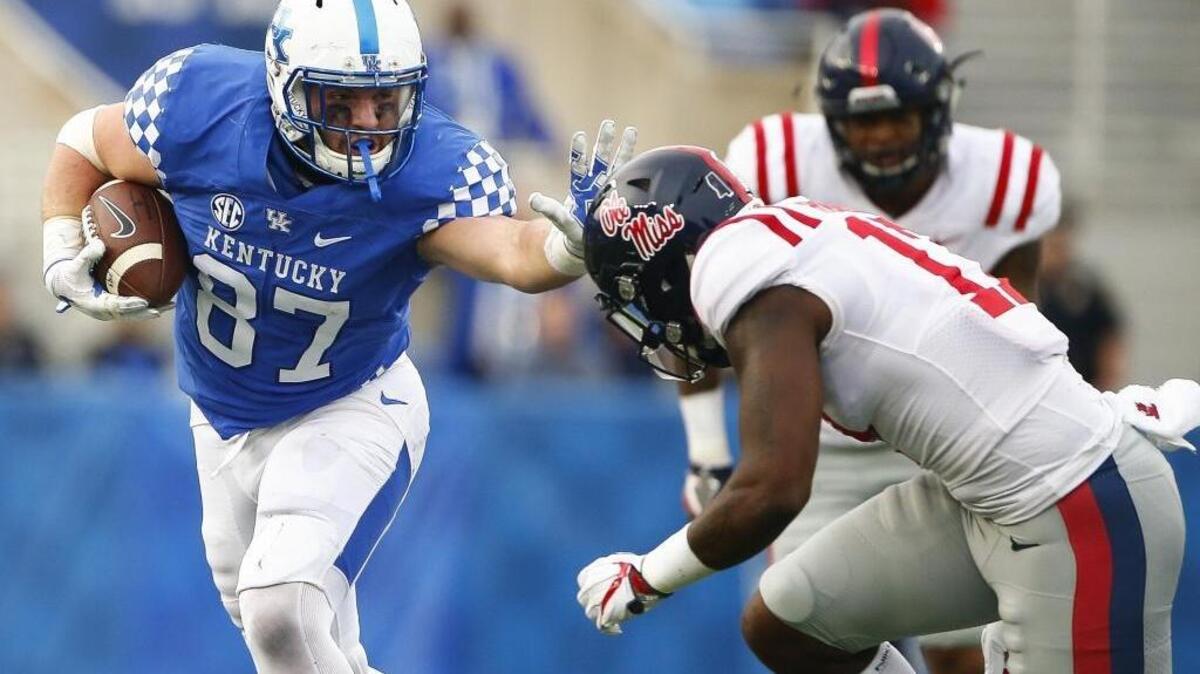 Kentucky tight end C.J. Conrad, shown stiff-arming Mississippi linebacker Willie Hibbler on Nov. 4, is out for the rest of the season with a foot injury that requires surgery.
