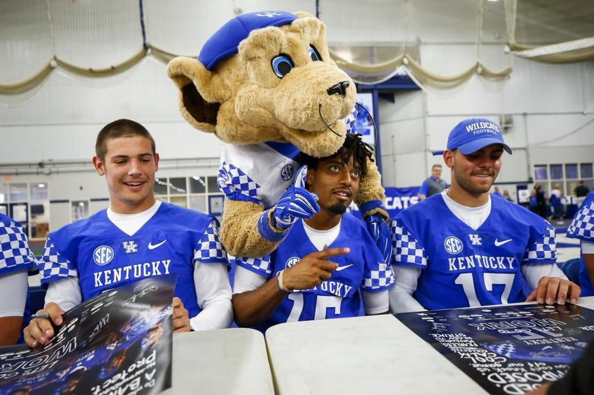 University of Kentucky mascot Scratch poses for a photo with quarterbacks Gunnar Hoak, from left, Stephen Johnson and Walker Wood during UK Football Fan Day at Nutter Field House in Lexington, Ky., Saturday, Aug. 5, 2017.