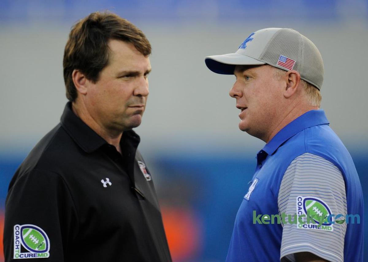 Kentucky Coach Mark Stoops, right, has led the Wildcats to four straight victories over South Carolina. Stoops talked with Gamecocks head man Will Muschamp before the 2016 meeting between the teams in Lexington.