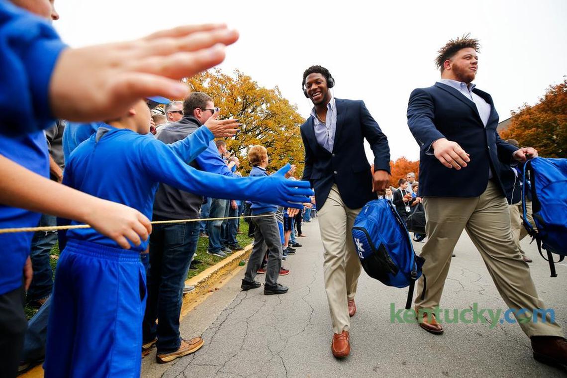 Kentucky linebacker Josh Allen, left, and nose tackle Matt Elam greeted fans during the Cat Walk before Kentucky’s game against Mississippi at Kroger Field last season.