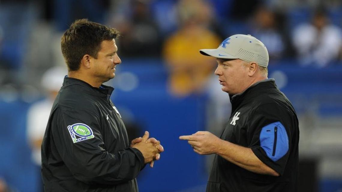 Mark Stoops, right, talked to offensive coordinator Shannon Dawson prior to the Kentucky-Missouri football game in 2015.