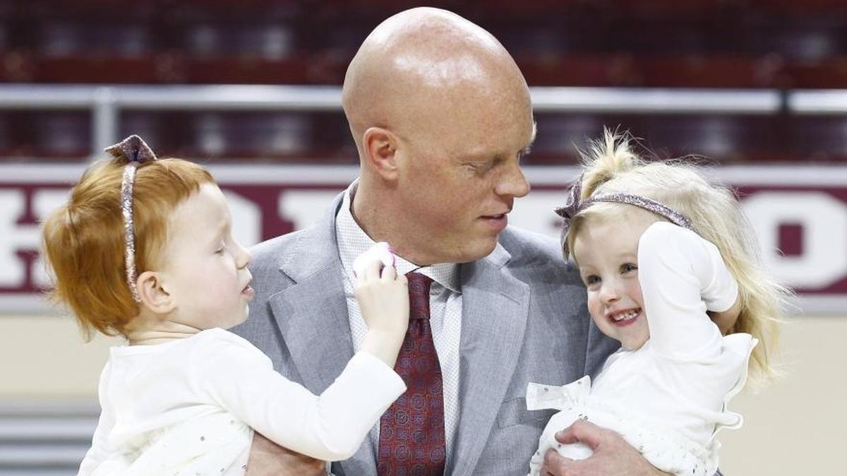 A.W. Hamilton held his daughters Charleigh, 4, left, and Andi, 2, before his introductory news conference in Richmond Wednesday as the new Eastern Kentucky University men’s basketball coach.