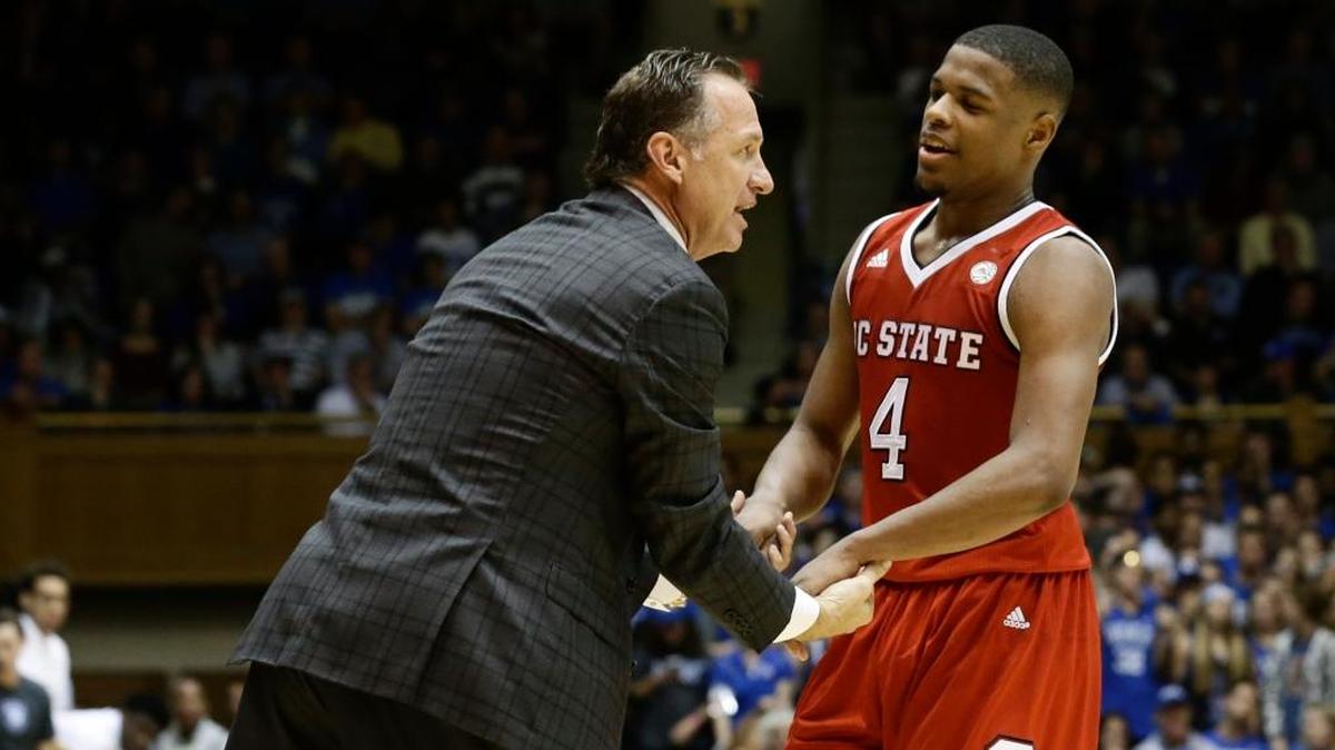 North Carolina State’s Dennis Smith Jr. was congratulated by Coach Mark Gottfried during a game in 2017. An attorney for former Adidas executive Jim Gatto admitted during trial Tuesday that her client paid Smith’s family $40,000 for the star guard to attend North Carolina State. Smith now plays for the NBA’s Dallas Mavericks.