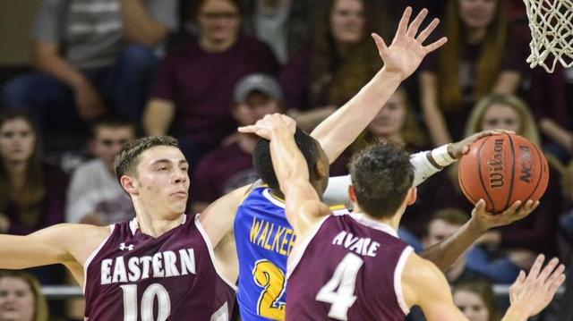 Eastern's Nick Mayo, left, defends a shot by Morehead's Jordan Walker in the second half, Saturday, Feb. 11 at EKU's McBrayer Arena in Richmond.