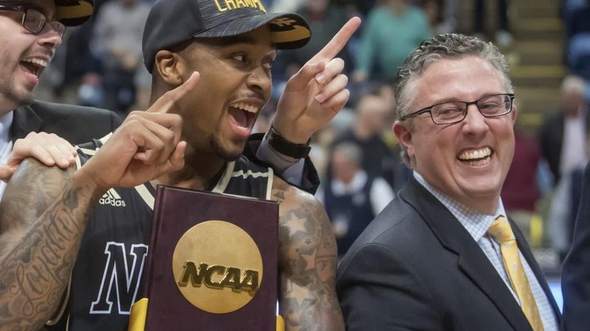 Nebraska Wesleyan's Deion Wells-Ross, left, and coach Dale Wellman smile after the team's win over Wisconsin-Oshkosh in the NCAA men's Division III championship college basketball game at Salem Civic Center in Salem, Va., Saturday, March 17, 2018. Nebraska Wesleyan won 78-72. (AP Photo/Don Petersen)
