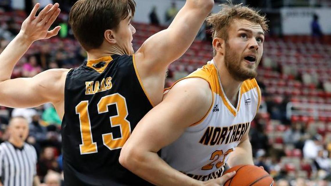 Northern Kentucky forward Carson Williams (23) drives on Milwaukee guard August Haas (13), of Denmark, in the first half of the Horizon League NCAA college basketball tournament championship game in Detroit, Tuesday, March 7, 2017.
