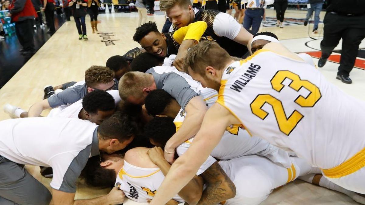 Northern Kentucky players celebrate their 59-53 victory over Milwaukee after the Horizon League NCAA college basketball tournament championship game in Detroit, Tuesday, March 7, 2017.