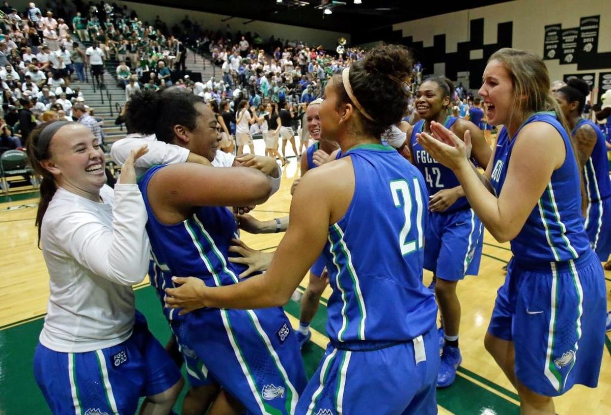 Members of the Florida Gulf Coast team surrounded China Dow, second from left, as they celebrate defeating Stetson 77-70 in the Atlantic Sun Conference championship game on March 12. Dow was named MVP of the tournament.
