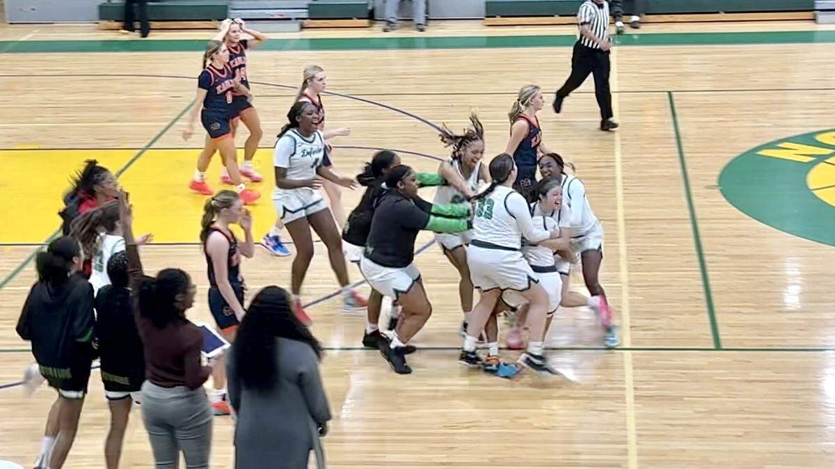 Bryan Station players swarm teammate Elayna Ward after the sophomore guard made a 3-pointer for a 41-40 win over Madison Southern as time expired in their game Wednesday at Bryan Station High School.