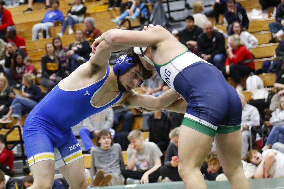 Henry Clay’s Trae White, left, grapples with Great Crossing’s Jack Finley in the 132 finals at the Region 6 Championships at Frederick Douglass High School on Saturday.