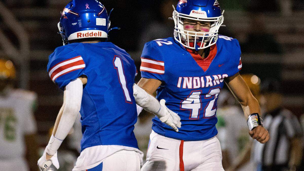 Madison Central’s Brock Eads (1) high-fives Brady Hensley (42) after a play during their game against Bryan Station last season. The two came up with a some clutch plays late against Paul Laurence Dunbar on Friday.