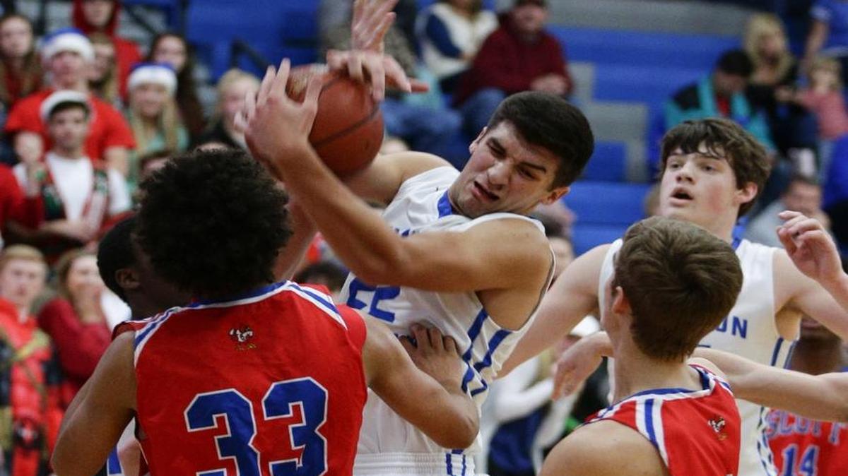 Lexington Christian’s Kyle Rode pulled down a rebound in traffic against Scott County on Dec. 7, 2016, in Lexington.