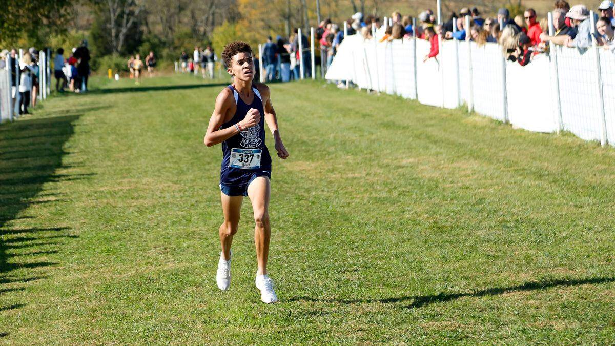 Lafayette’s Xavier Richardson eyes the clock as he nears the finish line of the boys Class 3A Region 6 Cross Country Championship at Bourbon County Park in Paris on Saturday.