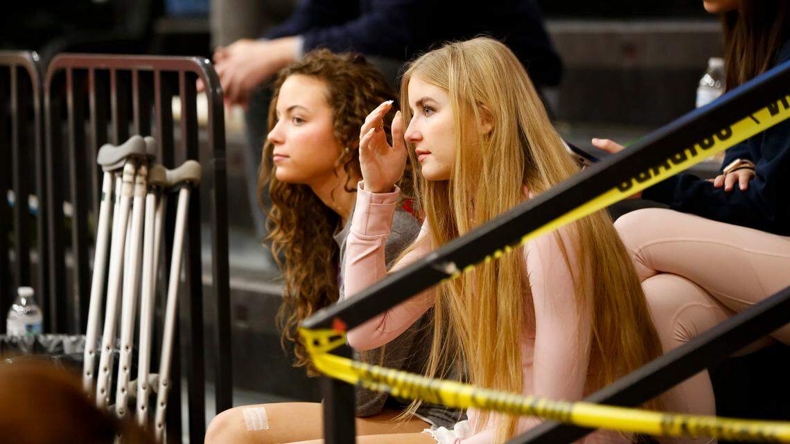 West Jessamine’s Ariana McLoney, left, and Isabella Lewis, who both suffered season-ending injuries this season, watched their teammates take on Mercer County during the Colts’ 58-37 win over the Titans at West Jessamine High School on Friday.