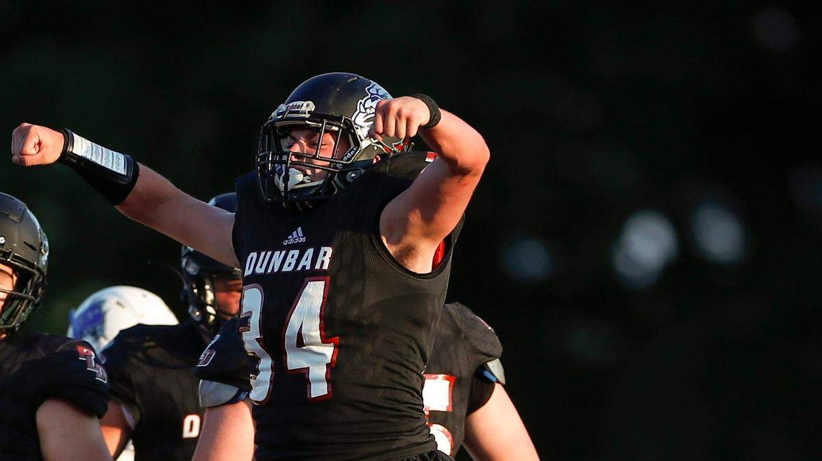 Paul Laurence Dunbar’s Mason Hayslett (34) celebrates after sacking Breathitt County’s Jaylen Turner (1) during their game at Paul Laurence Dunbar High School in Lexington, Ky., Friday, Aug. 20, 2021. Paul Laurence Dunbar beat Breathitt County 69-28.