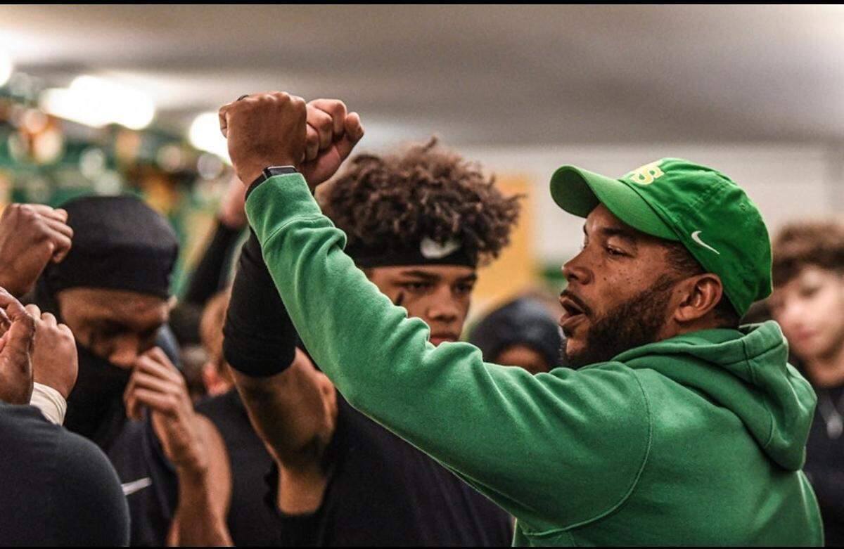 Bryan Station High School assistant coach J.T. Haskins Sr. huddled up a group a players in the locker room during the 2022 season.