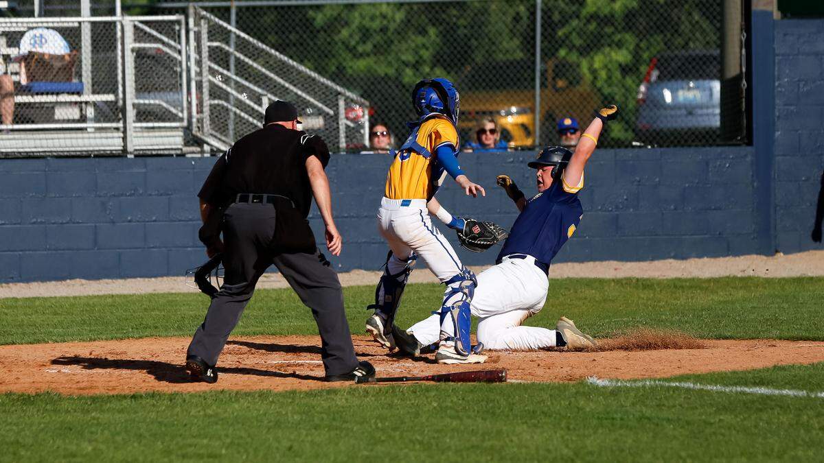Franklin County’s Jack Ross slides under the tag applied by Henry Clay’s Mason Draper during the Flyers’ 4-0 win against Henry Clay in the 11th Region baseball tournament on Tuesday.