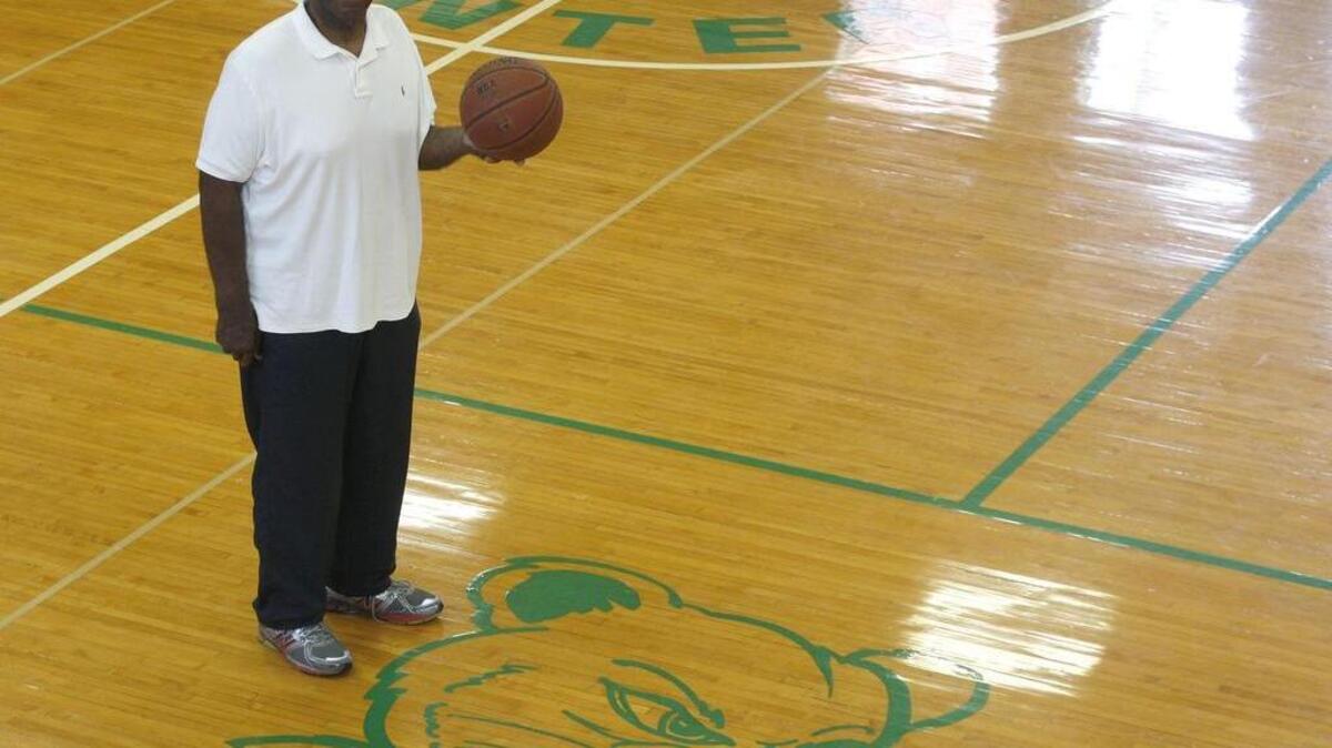 George Wilson stood by the old Dunbar High School mascot, the Bearcat, at the Dunbar Community Center on Wednesday, “These games used to be packed,” he said. “You had to get here early just to get a seat.”