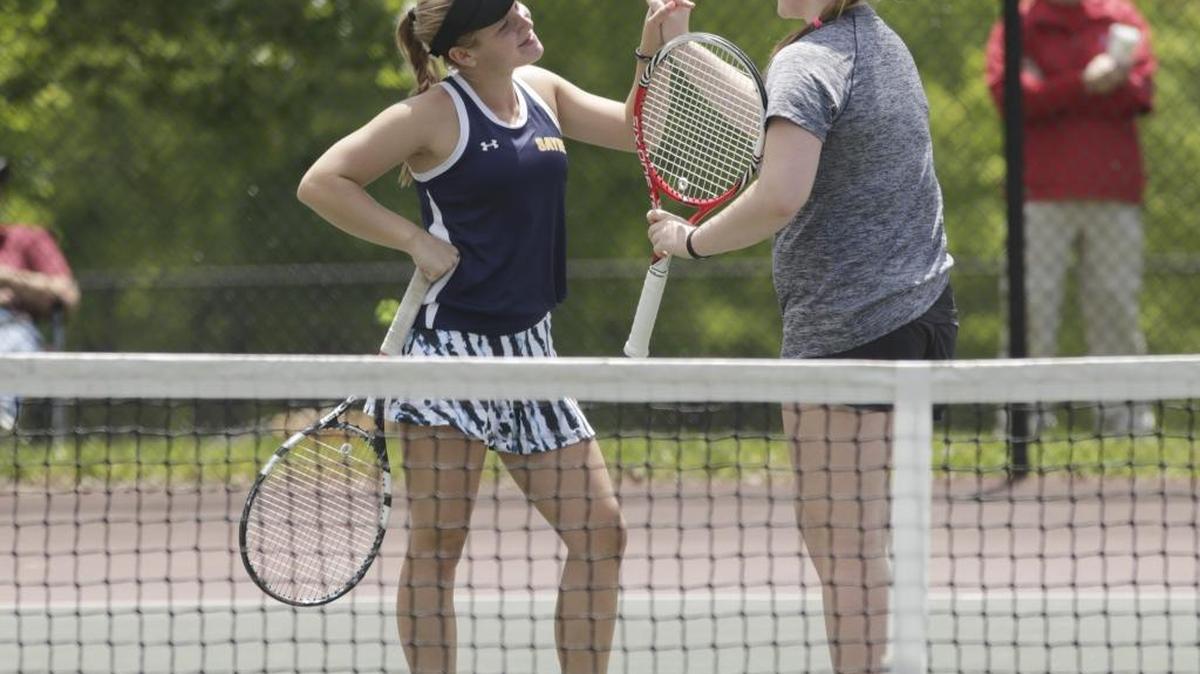 Sayre’s Caroline Hager, left and Grace Headley high-fived during the KHSAA tennis tournament at Shillito Park in Lexington, Ky, on May 19, 2016. Sayre beat Corbin’s Emily Morton and Cora Stevens.