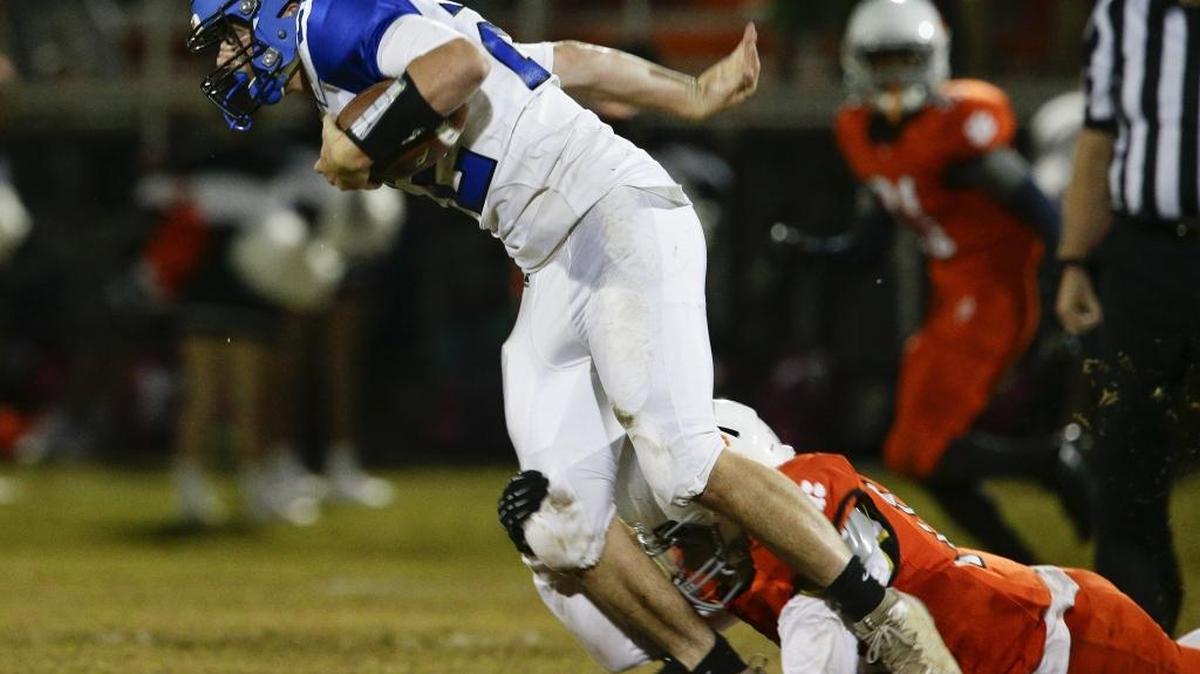 Bracken County's Tad Fisher, brought down by Paris Jacques Dumphord, 1, after a gain as Paris played Bracken County on Friday September 30, 2016 in Paris, Ky.