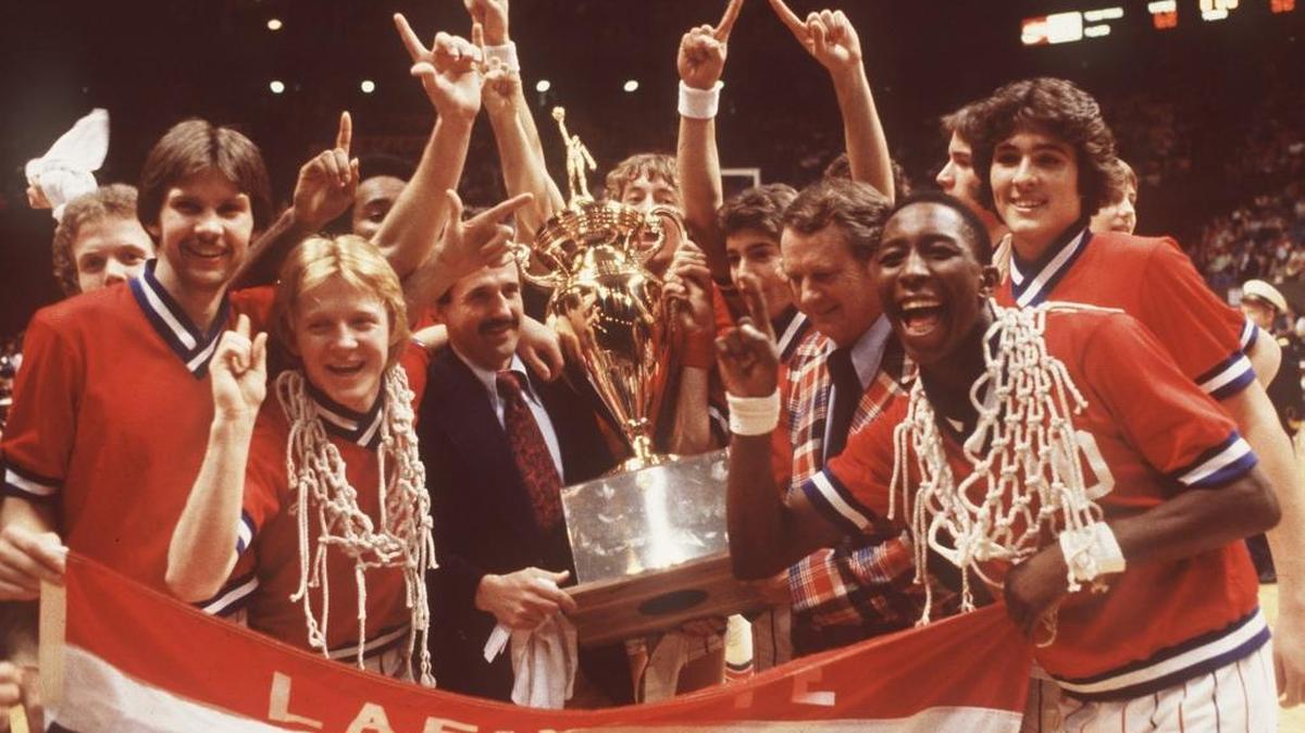 1979 FILE PHOTO. The Lafayette Generals basketball team celebrates with the championship trophy after winning the Boys Sweet 16 March 17, 1979 in Rupp Arena, Lexington Kentucky. Third from the left, with the net around his neck is Junior Johnson, assistant coach Donnie Harville and head coach Jock Sutherland hold the trophy, Dirk Minniefield, front right, also has one of the nets around his neck.