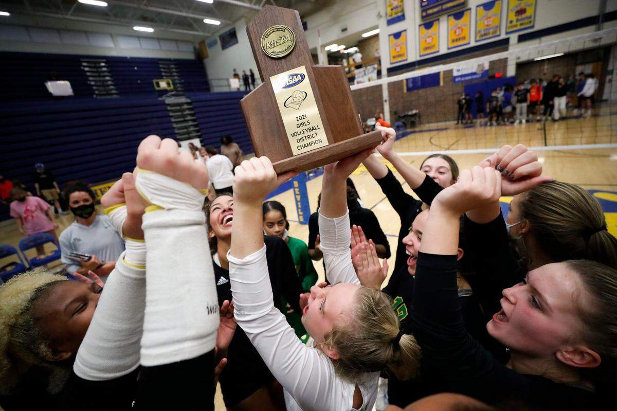 Bryan Station celebrates with the trophy after winning the 42nd District volleyball finals against Frederick Douglass at Henry Clay High School on Oct. 20, 2021.