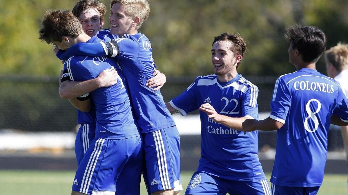 Covington Catholic players celebrate with Griffin Lamb, second from left, following his goal in the second half against Louisville Collegiate during the KHSAA state quarterfinals at Ishmael Stadium in Lexington, Ky., Saturday, October 29, 2016.