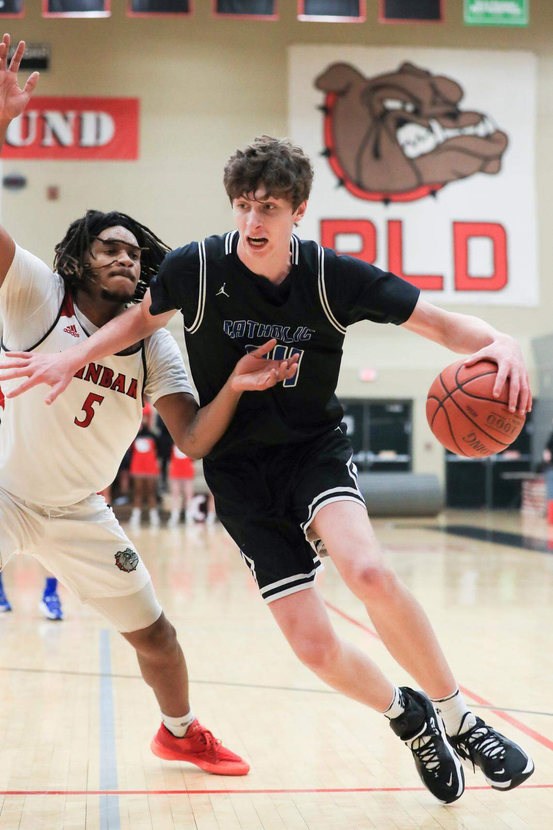 Lexington Catholic’s center Reece Potter (34) fights to get to the goal.