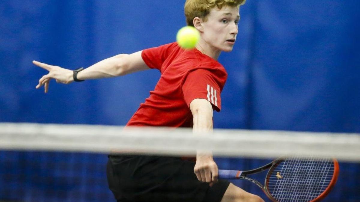 Paul Laurence Dunbar's Matt Halpin returns the ball during his singles match against Henry Clay's Noah Tapp during the 11th Region tennis finals at the University of Kentucky, Thursday, May 11, 2017.