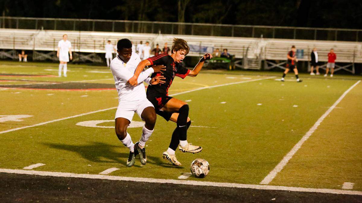 Henry Clay’s Pierre Charles Jean Baptiste, left, battled with Paul Laurence Dunbar’s Jackson Brooks for the ball during the Blue Devils’ 4-1 win at Paul Laurence Dunbar High School on Tuesday.