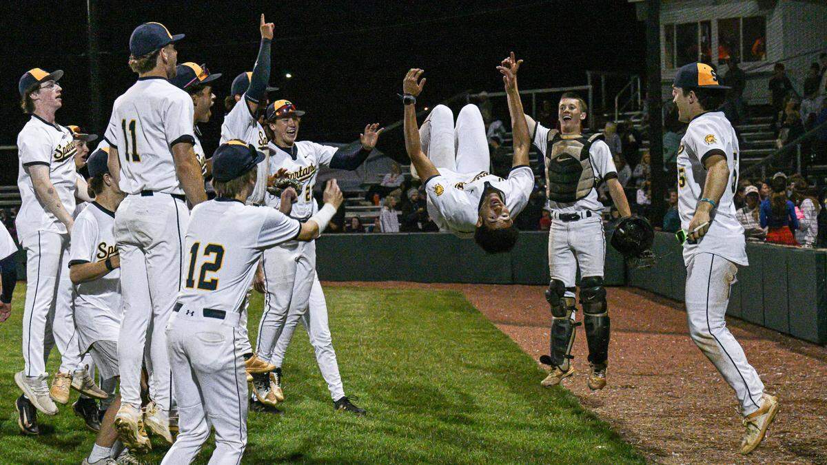 Sayre pitcher Jaxson Howard (35) does a backflip in celebration with his teammates after the Spartans’ 7-4 victory against Fredrick Douglass in the 42nd District championship game.