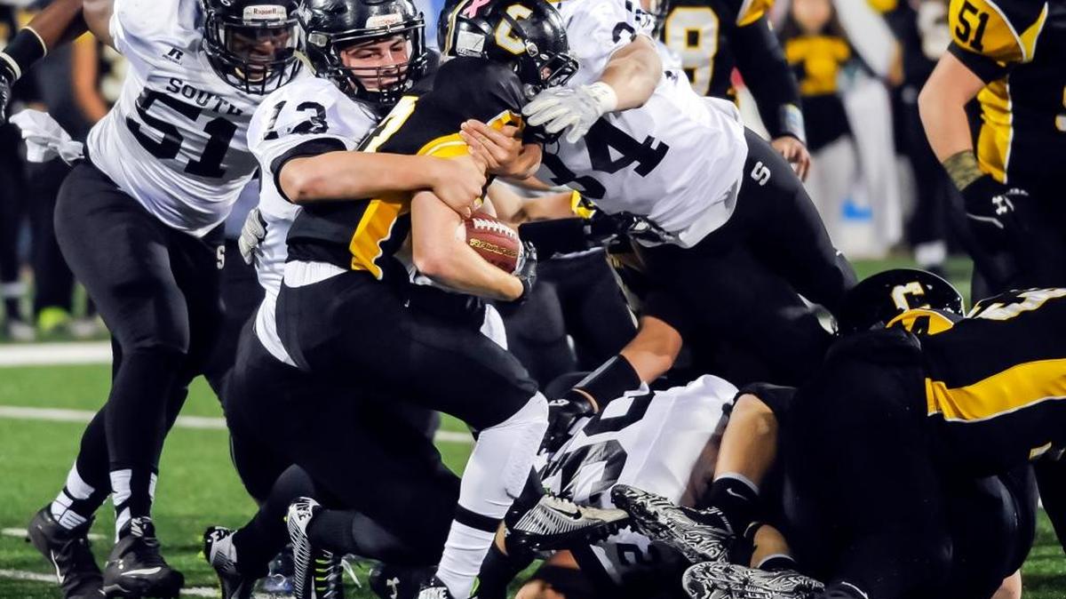 South Warren’s Zach Haynes (13) and Devante Colton (34) brought down Johnson Central’s Bryce Skaggs (23) during the Class 4A championship game.