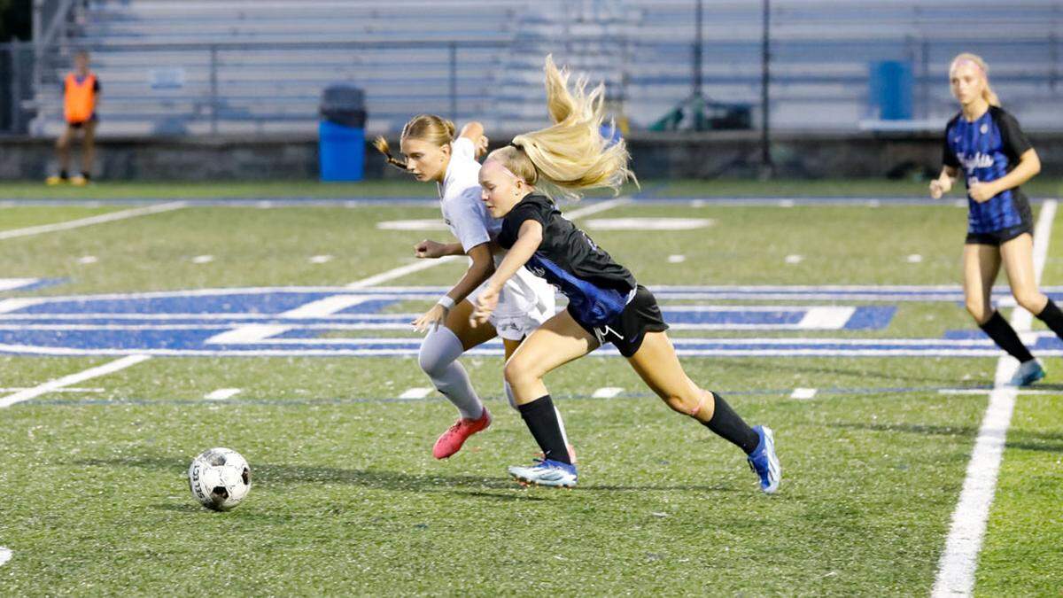 Frederick Douglass midfielder Ella Flynn, left, battled for a ball with Lexington Catholic’s Harper Ward during their game at Lexington Catholic High School on Sept. 23.