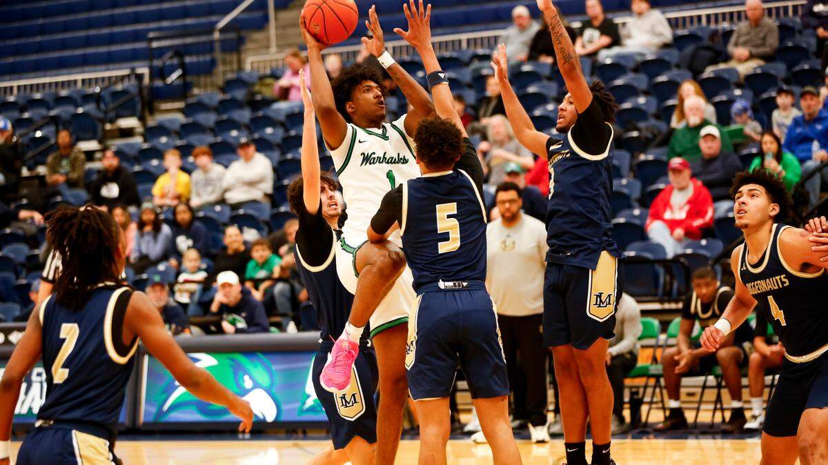 Great Crossing’s Vince Dawson (1) goes up for a shot among three Lloyd Memorial defenders in the Warhawks’ 59-50 win against the Juggernauts at Great Crossing High School in Georgetown on Saturday.