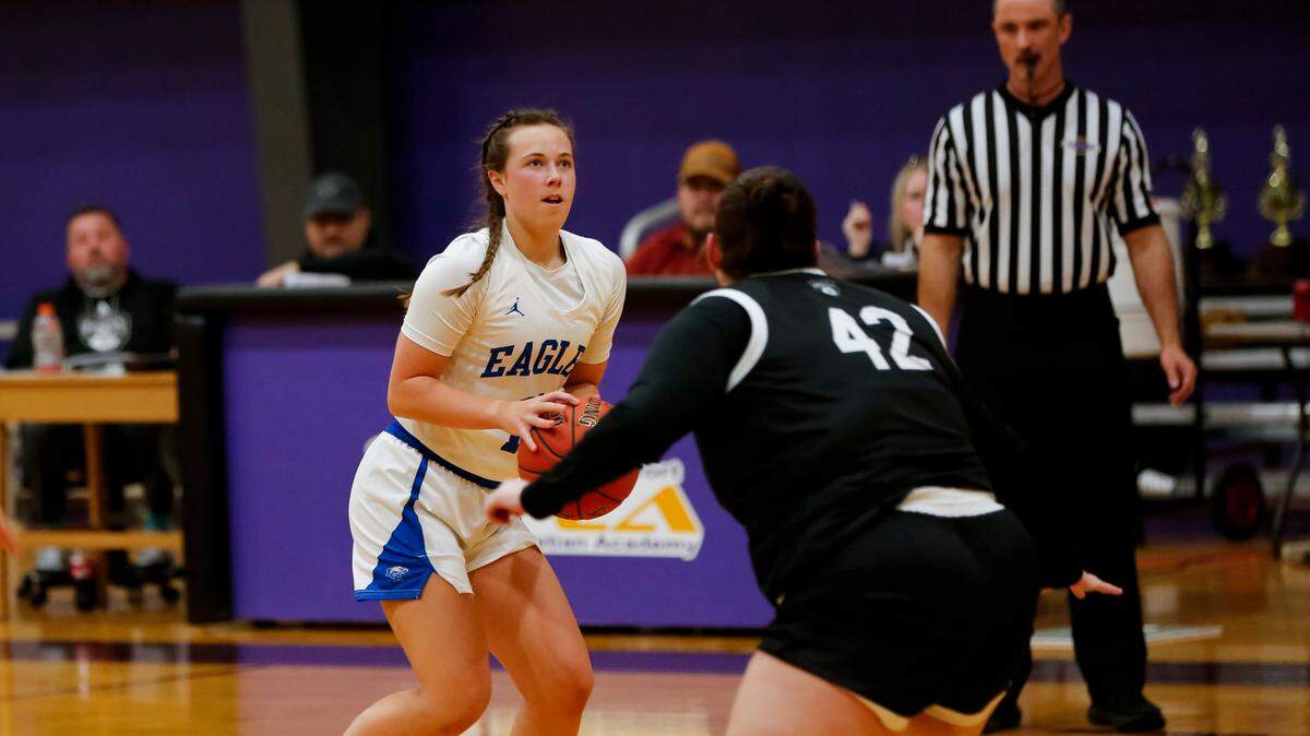 Lexington Christian’s Ella Gabbert, left, lined up a 3-point shot as Berea’s Tess McLin (42) approached during the Eagles’ 71-20 win in the girls 11th Region All “A” Classic tournament at The Frankfort Christian Academy in Frankfort on Sunday.