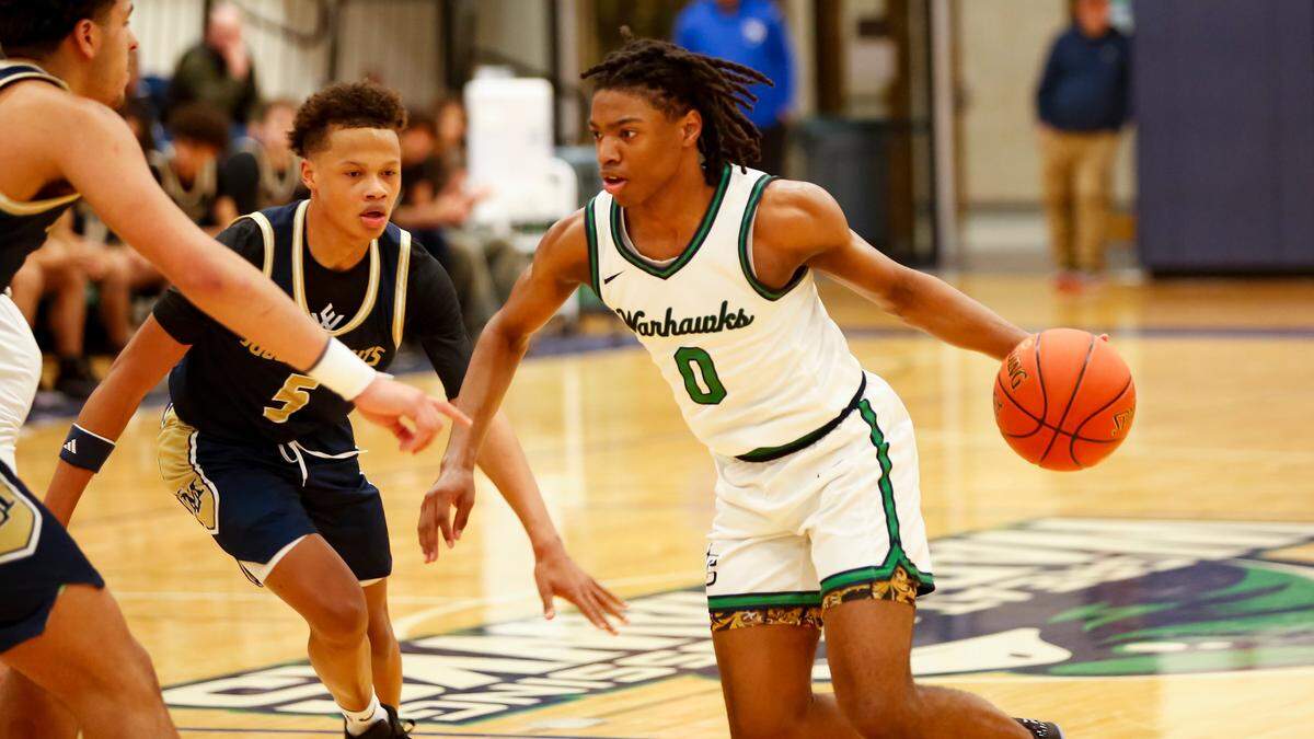 Great Crossing junior point guard LJ Holman (0) took on Lloyd Memorial defenders, including Jayden Humphrey (5), in the Warhawks’ 59-50 win against the Juggernauts at Great Crossing High School in Georgeown on Saturday.