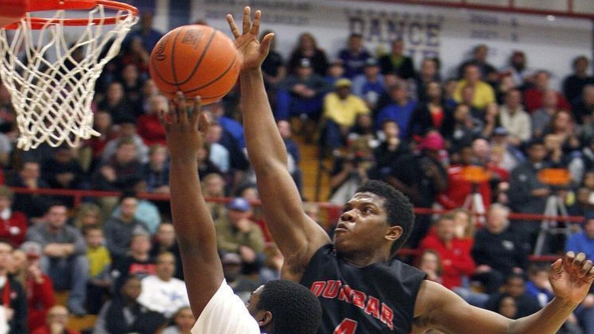 Paul Dunbar’s Dontell Brown blocked a shot by Lafayette’s Jajuante Carpenter in the championship game of the 43rd District boys’ tournament at Lafayette on Friday, Feb. 26, 2016.