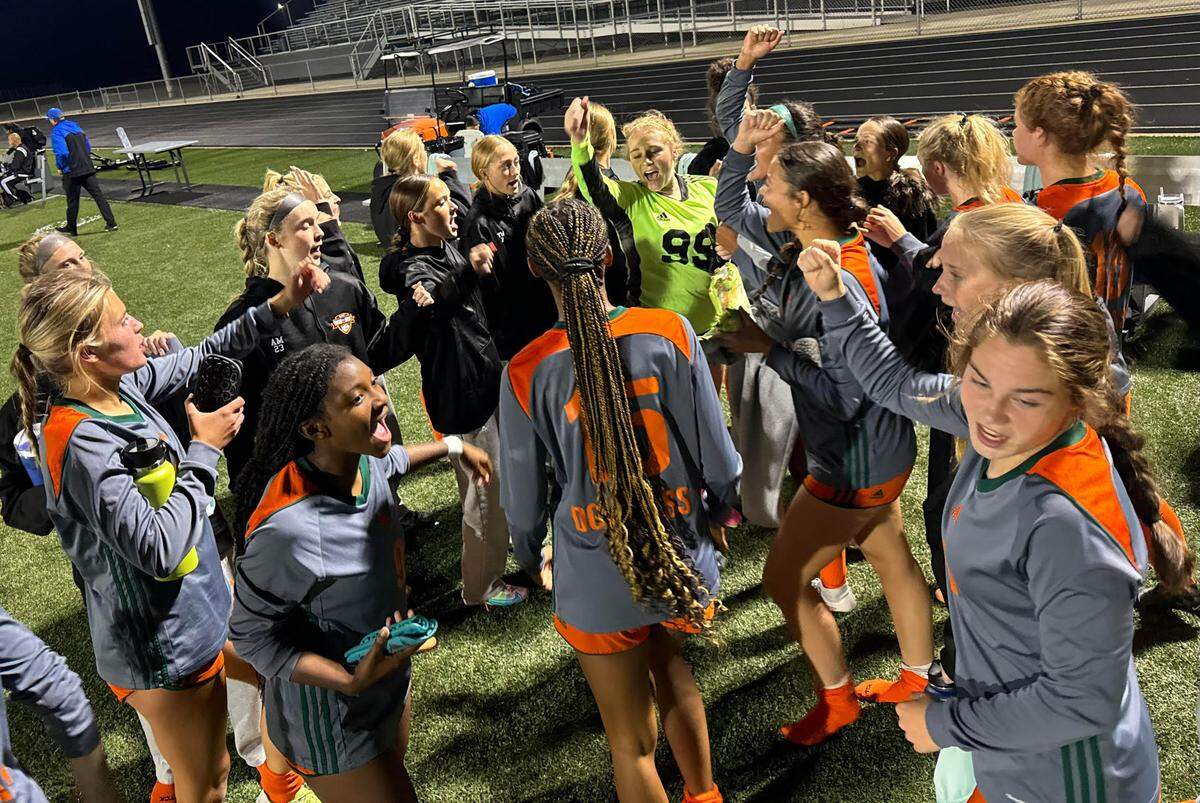 Frederick Douglass players huddle up for their team cheer after defeating Lafayette 2-1 in girls high school soccer’s 11th Region Tournament quarterfinals at Frederick Douglass High School on Oct. 9, 2023.