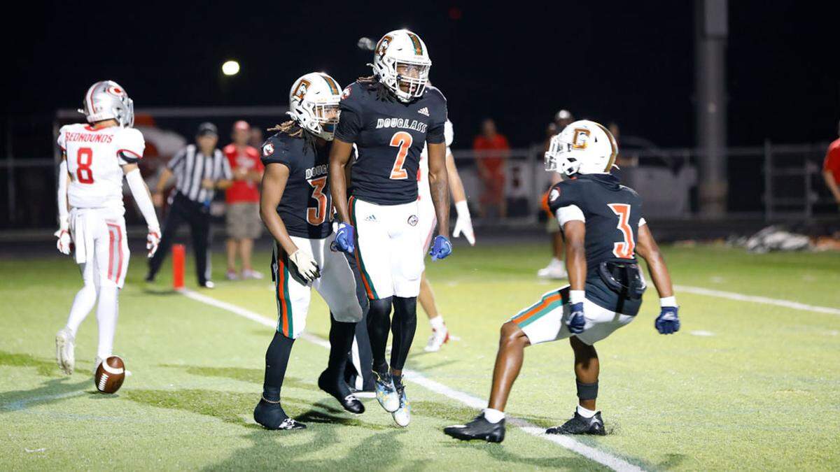 Frederick Douglass wide receiver Aveion Chenault (2) celebrates a second-half touchdown with teammate Pharo Watts during the Broncos’ 35-14 win over Corbin at The Farm on Friday.