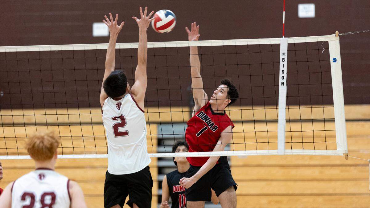 Paul Laurence Dunbar’s Israel Hurtado (7) tried to hit around the outstretched arms of Tates Creek’s Max Lunsford (9) during their volleyball game at Tates Creek High School on Thursday.