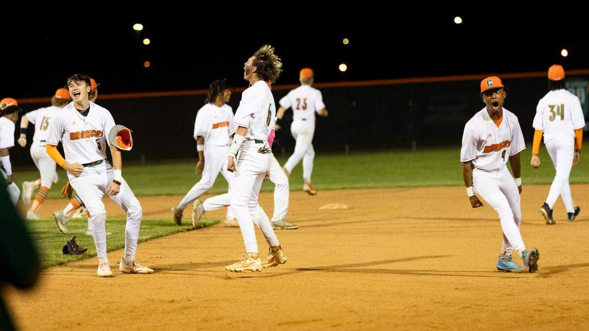 Frederick Douglass players, including Braxton Hensley (5), Reece Harbison (6) and Cameron Atkins (4), celebrate the host Broncos’ 1-0 win against Scott County in the 42nd District Tournament baseball semifinals Monday.