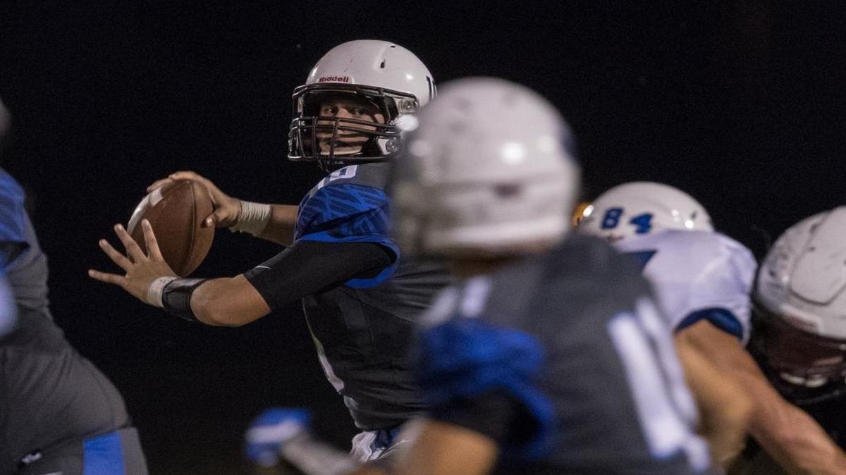 Lexington Christian’s Brayden Miller, shown completing a pass to Caelan Lebryk earlier this season against Estill County, threw three TD passes against Fairview on Friday night.