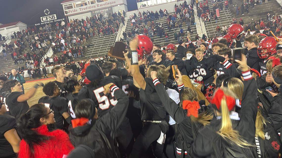The Mayfield Cardinals celebrate with their KHSAA state semifinalist trophy after defeating Lexington Christian 38-28 on Friday at War Memorial Stadium in Mayfield.