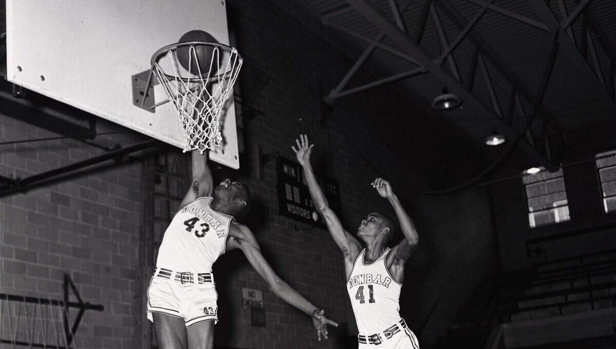 Julius Berry slammed in a bucket with teammate Preston Logan in two during a Dunbar High School Bearcats practice in 1957.