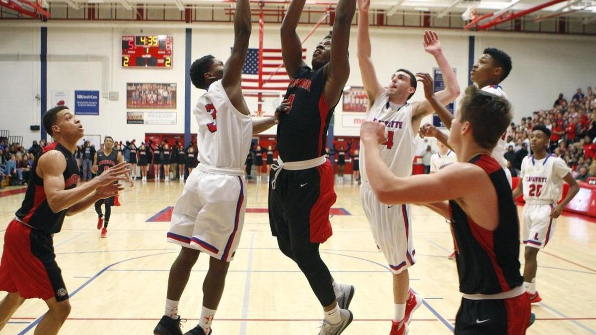 Paul Dunbar's Dontell Brown shoots against Lafayette in the championship game of the 43rd district boys basketball tournament at Lafayette's Jackson-Carlisle Gymnasium in Lexington, Ky., Friday, February 26, 2016.