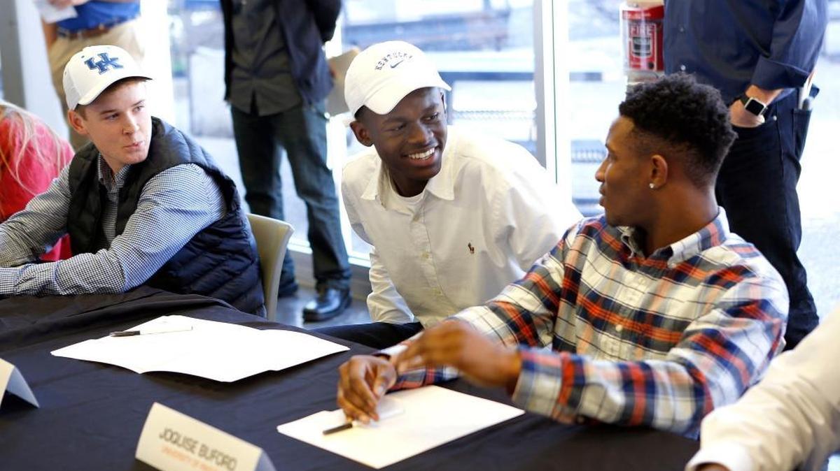 L-R: Collin Rose, who signed with UK soccer, Aime Mabika, who also signed with UK soccer, and Joquise Buford, who signed to play football at Pikeville, talked during signing ceremony held at Henry Clay High School in Lexington, Ky., Wednesday, February 03, 2016. Ten Henry Clay student athletics signed with their various colleges and universities. One of the ten was Davonte Robinson who signed to play football at UK.