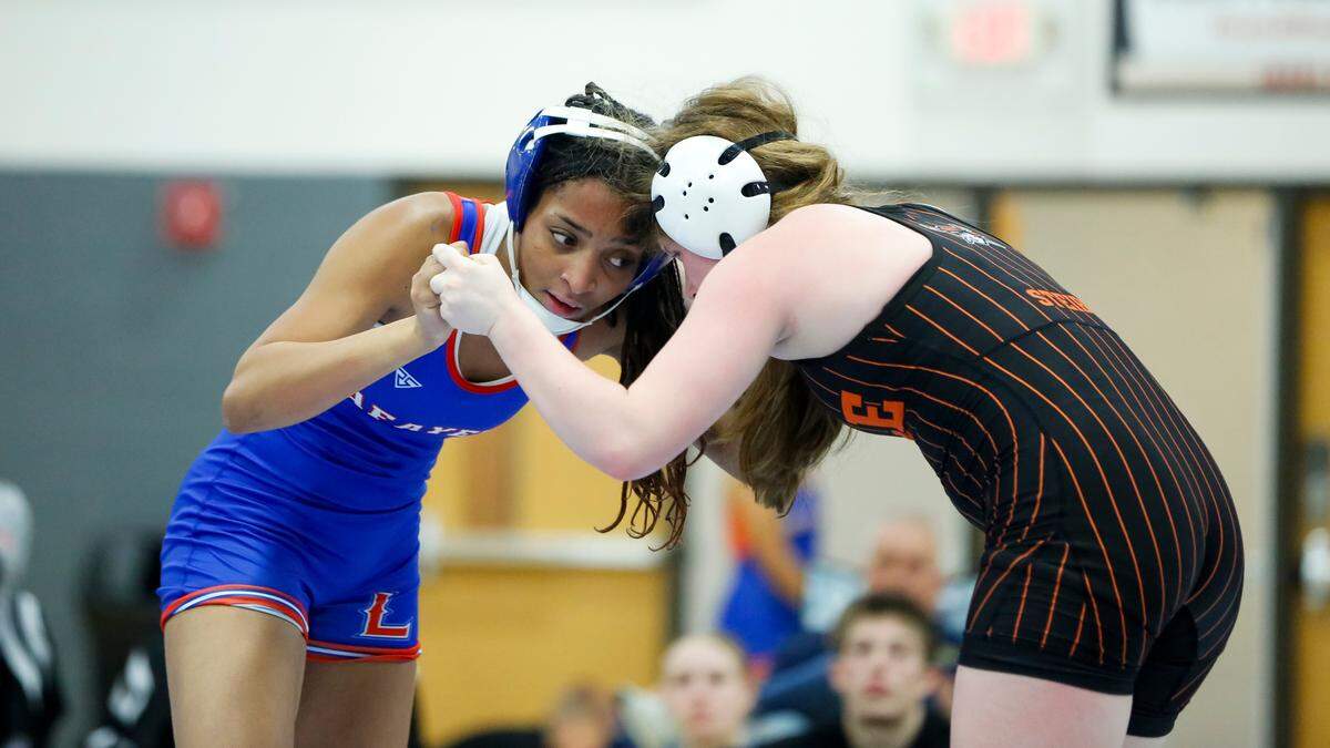 Lafayette’s Trinity Matthews squares up against Ryle’s Preslee Steiber in the 138 finals of the Girls Region 8 Wrestling Championships at Walton-Verona High School in Walton on Saturday.