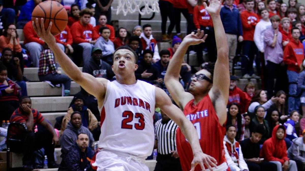 Paul Dunbar’s Darius Williams, left, drove for a basket during a 73-42 win against Lafayette on Jan. 26.